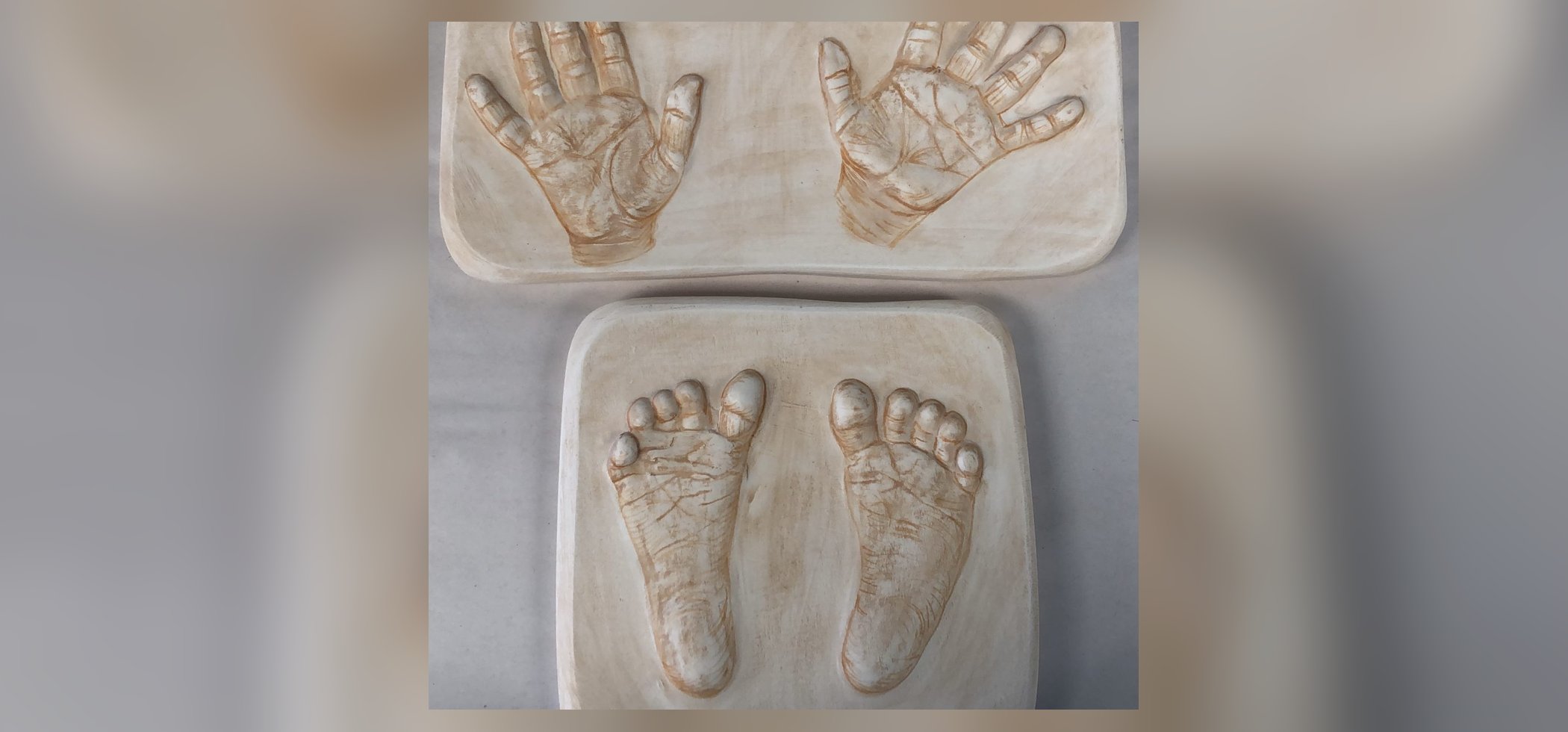 Raised casts of baby hands and feet on soft-glazed plaques